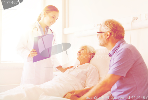 Image of senior woman and doctor with clipboard at hospital