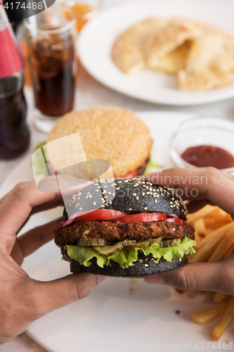 Image of Man eating burgers