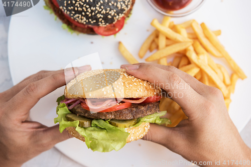 Image of Man eating burgers