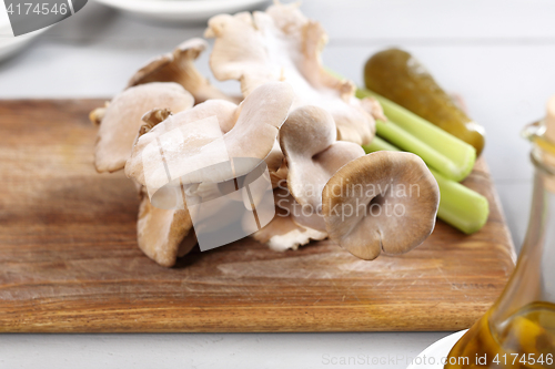 Image of Oyster mushrooms mushrooms and olive oil. oyster mushrooms in the kitchen.