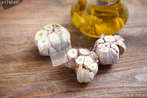 Image of Olive oil with garlic cloves.