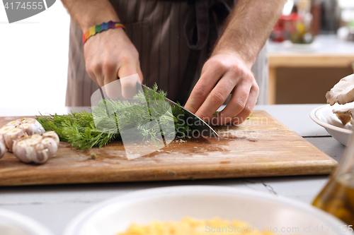 Image of Cook the sliced fennel. Cautious chopping vegetables.