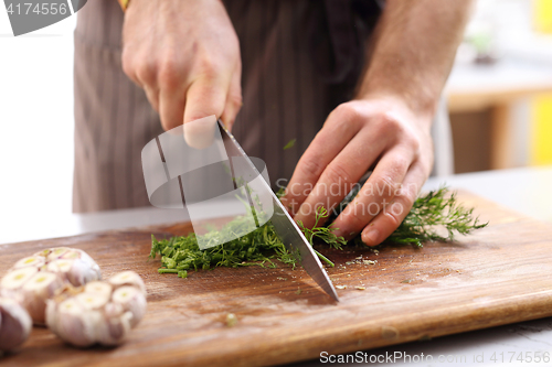 Image of Cook the sliced fennel. Cautious chopping vegetables.