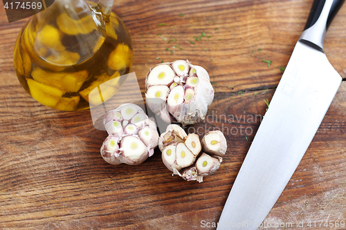 Image of Olive oil with garlic cloves.