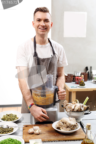 Image of Cook. The young chef prepares a vegetable dish vegan 