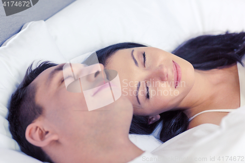 Image of happy couple sleeping in bed