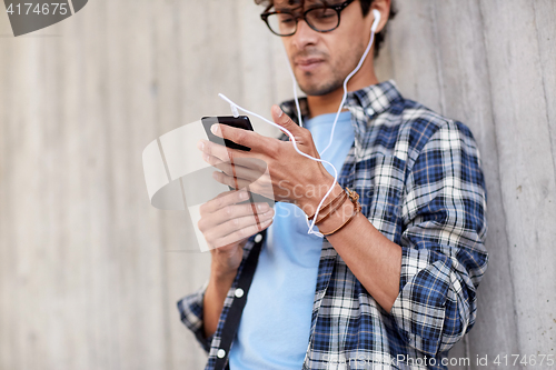 Image of man with earphones and smartphone listening music