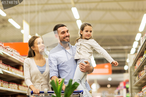 Image of family with food in shopping cart at grocery store