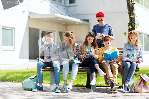 Image of group of students with notebooks at school yard