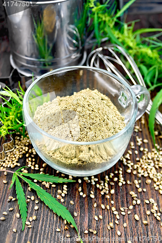 Image of Flour hemp in glass cup with leaf on dark board