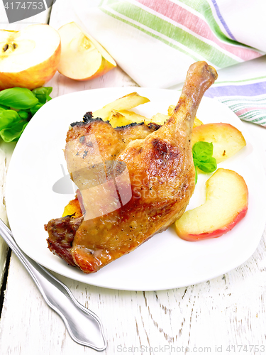 Image of Duck leg with apple in plate on light board