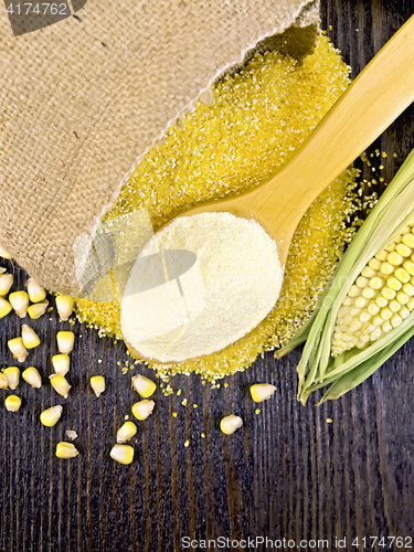 Image of Flour corn in spoon with grains on board top