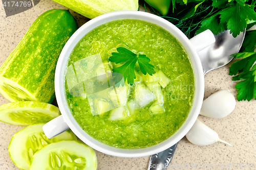 Image of Soup cucumber in white bowl on stone table top