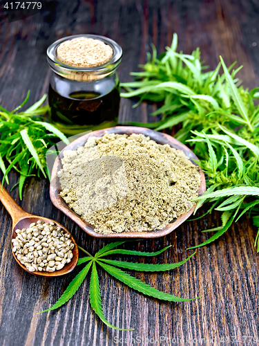 Image of Flour hemp in bowl with oil and spoon on dark board