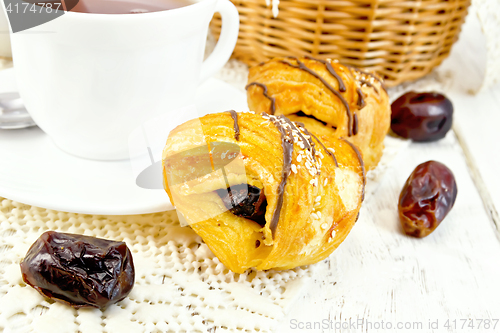 Image of Cookies with dates and tea in white cup on board