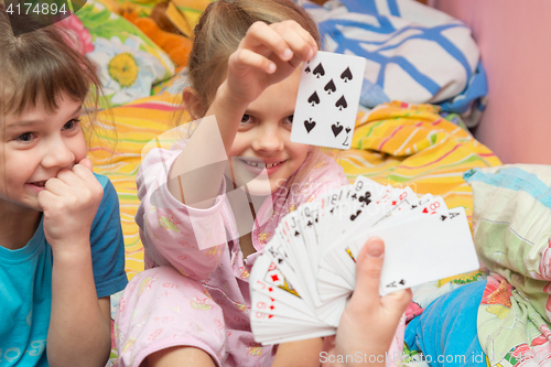 Image of Children happily pull the card from the card fan