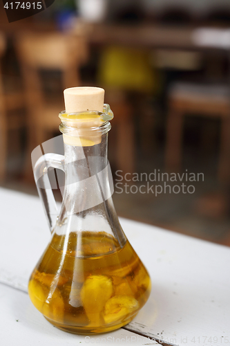 Image of Olive oil with garlic cloves.