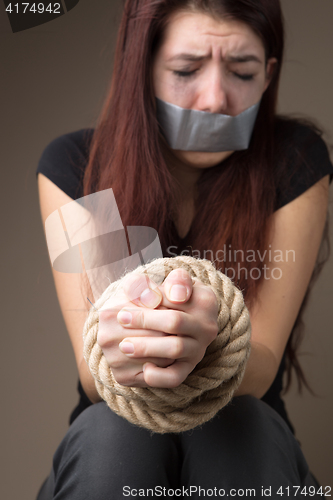 Image of Miserable victim with sealed mouth