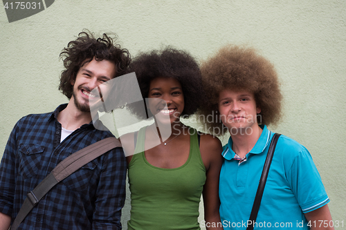 Image of multiethnic group of happy three friends