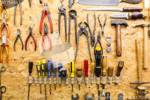 Image of work tools hanging on wall at workshop