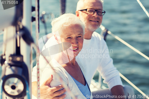 Image of senior couple hugging on sail boat or yacht in sea