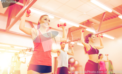 Image of group of people working out with dumbbells