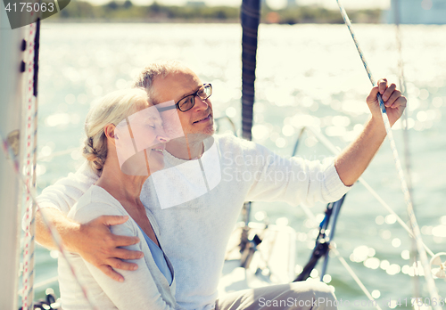 Image of senior couple hugging on sail boat or yacht in sea