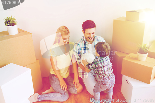 Image of happy family moving to new home and playing ball