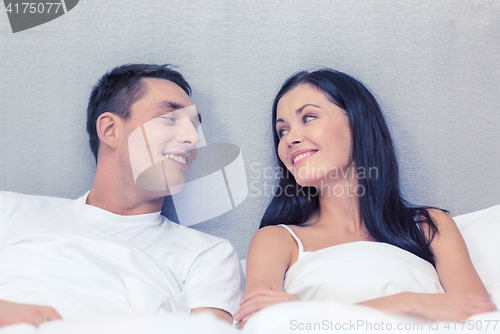 Image of happy couple sleeping in bed