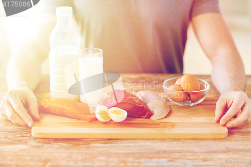 Image of close up of male hands with food rich in protein