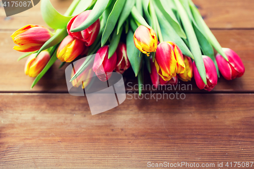 Image of close up of tulip flowers on wooden table