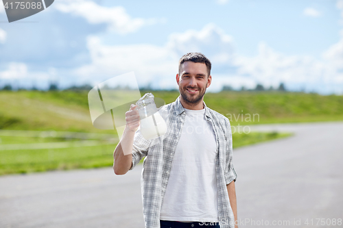 Image of man or farmer with jug of milk at countryside