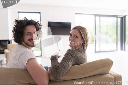 Image of Rear view of couple watching television