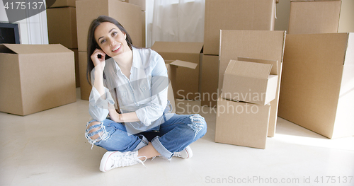 Image of Happy young woman chatting on her mobile