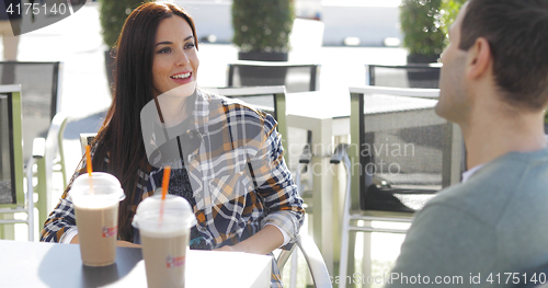 Image of Young couple enjoying takeaway beverages