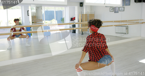 Image of Female dancer practices her moves in studio