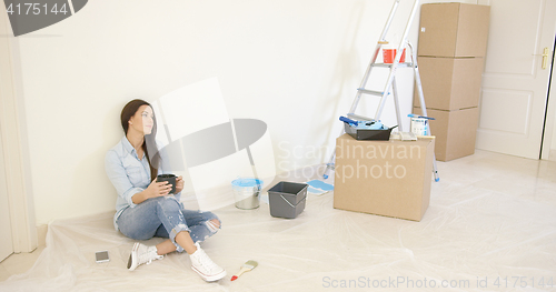 Image of Tired young woman relaxing during renovations