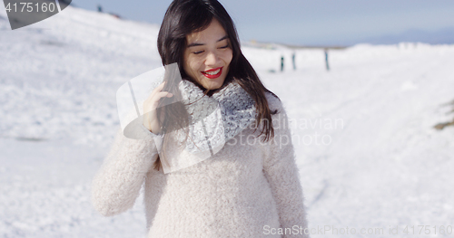 Image of Smiling asian girl in woolen sweater relaxing