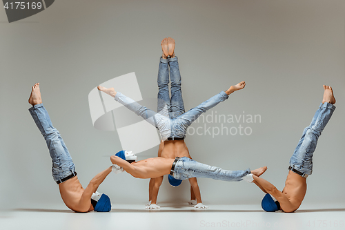 Image of The group of gymnastic acrobatic caucasian men on balance pose