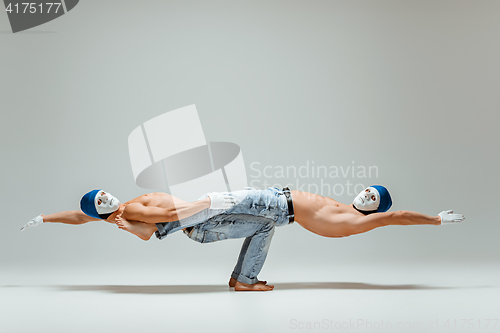 Image of The two gymnastic acrobatic caucasian men on balance pose