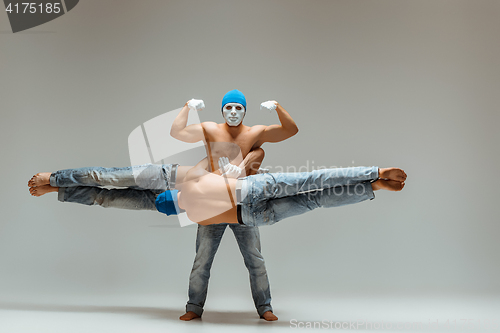 Image of The group of gymnastic acrobatic caucasian men on balance pose