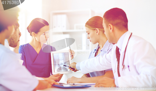 Image of group of doctors with x-ray on tablet pc at clinic