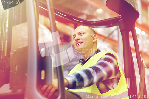 Image of man operating forklift loader at warehouse