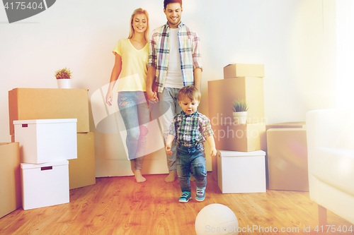 Image of happy family moving to new home and playing ball