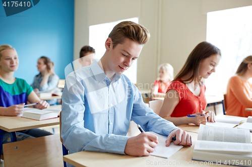 Image of group of students with books writing school test