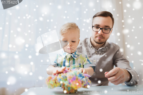 Image of father and son playing with ball clay at home