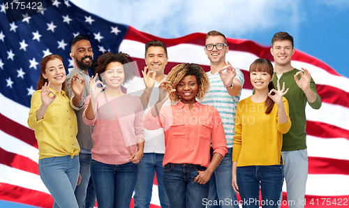 Image of international people showing ok over american flag