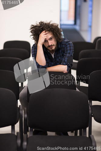 Image of A student sits alone  in a classroom