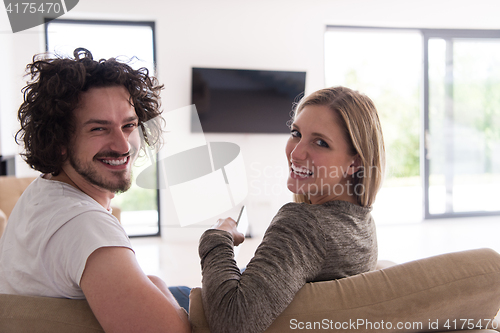 Image of Rear view of couple watching television