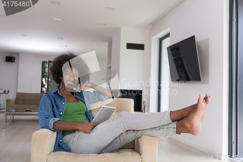 Image of african american woman at home with digital tablet